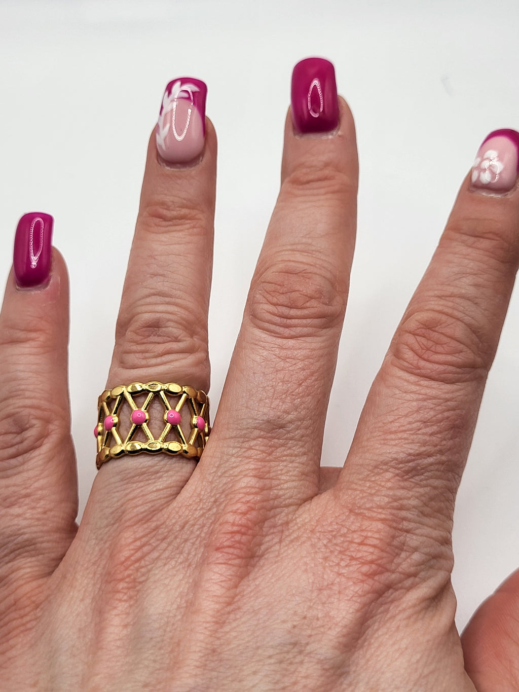 Bague acier inoxydable doré croisillons points roses
