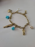 Bracelet doré charms animaux marins et étoile de mer bleu