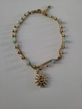 Chaîne de cheville dorée double rang soleil et perles bleu