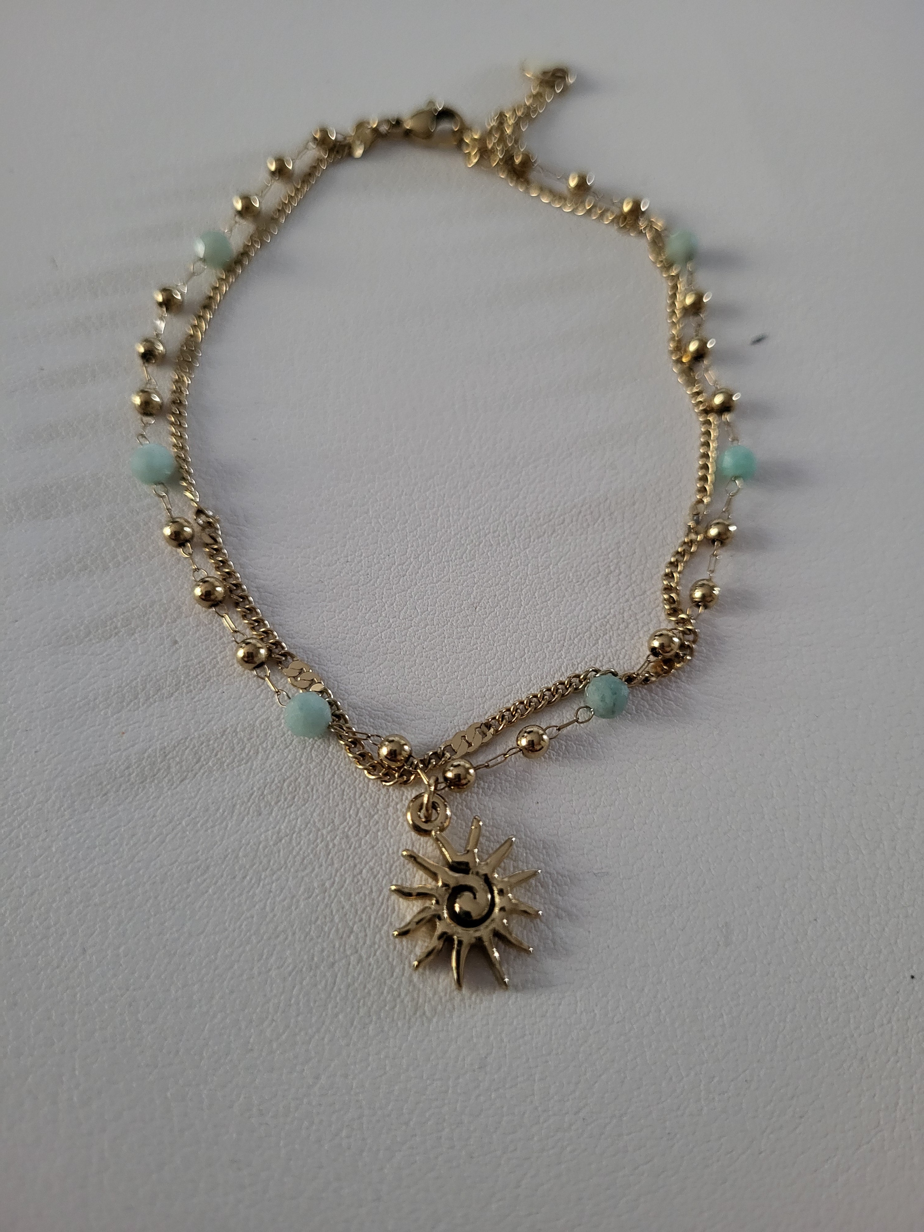 Chaîne de cheville dorée double rang soleil et perles bleu