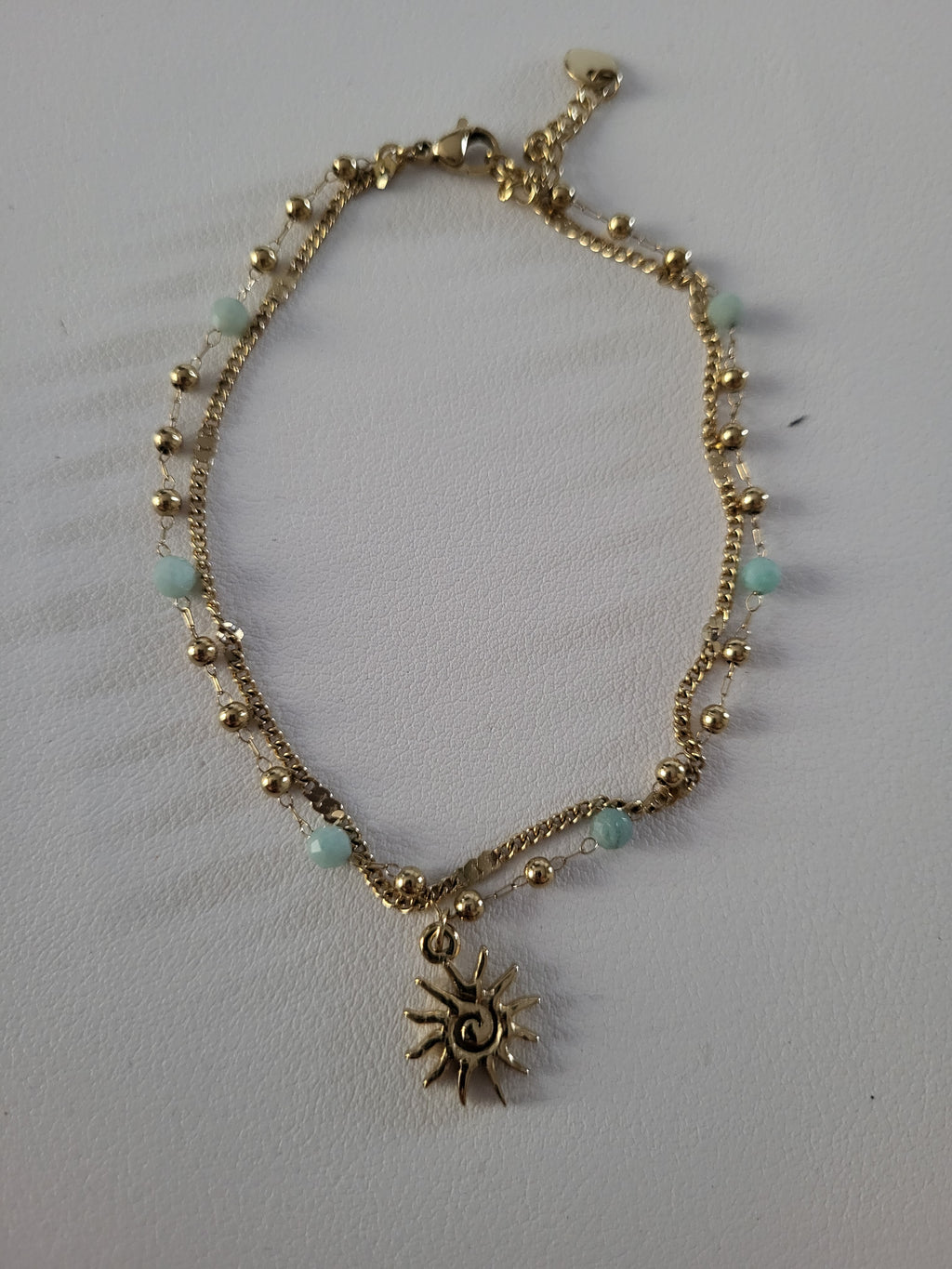 Chaîne de cheville dorée double rang soleil et perles bleu