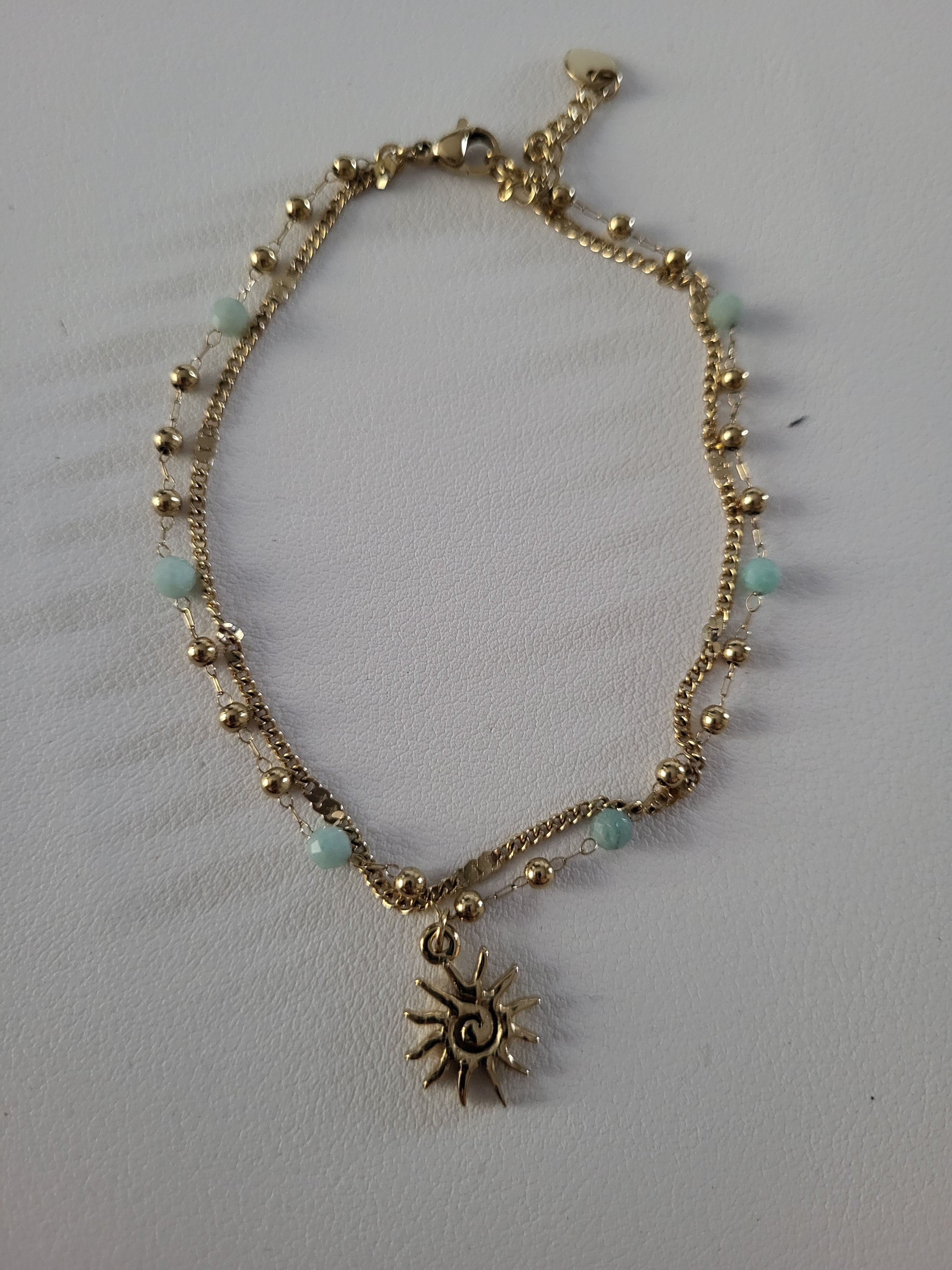Chaîne de cheville dorée double rang soleil et perles bleu