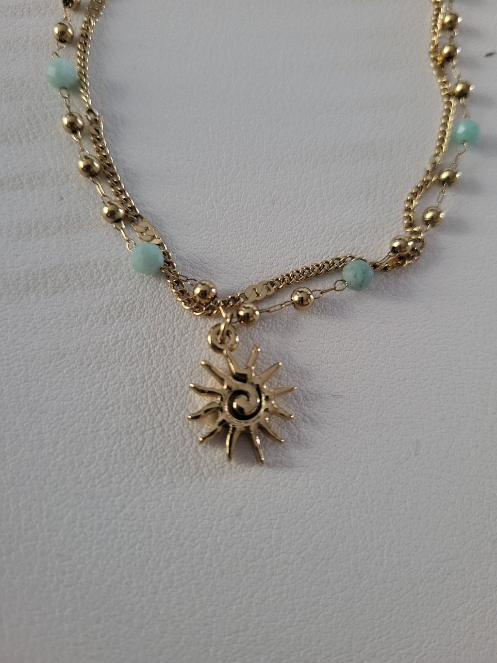 Chaîne de cheville dorée double rang soleil et perles bleu