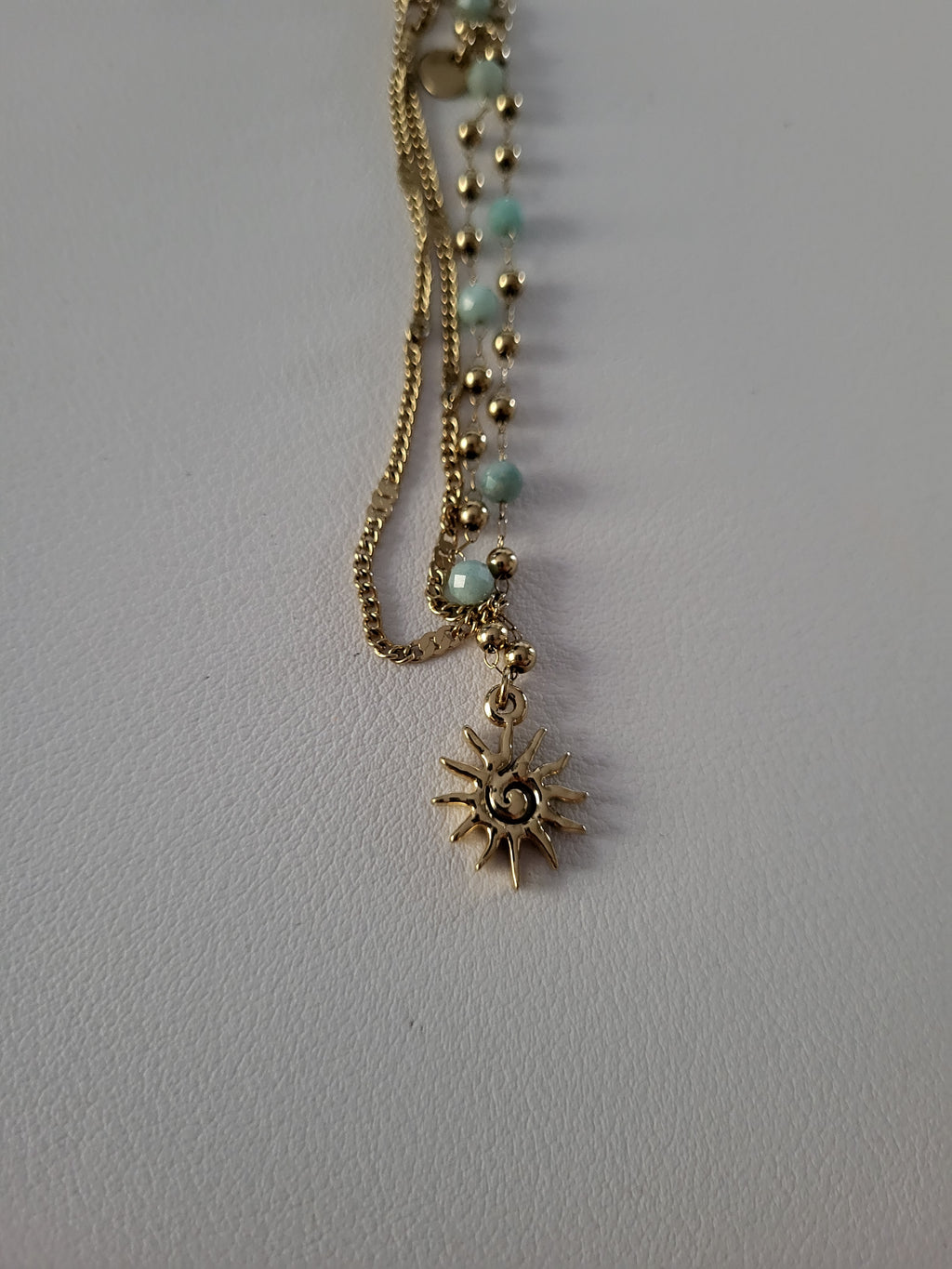 Chaîne de cheville dorée double rang soleil et perles bleu