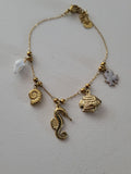 Bracelet à charms hippocampe et poulpe nacré doré