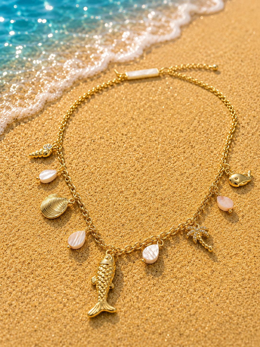 Collana dorata charms marini con palma e pietre rosa