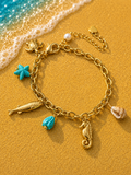 Bracciale dorato con ciondoli animali marini e stella marina blu