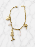 Bracelet doré charms marins palmier et pierres roses