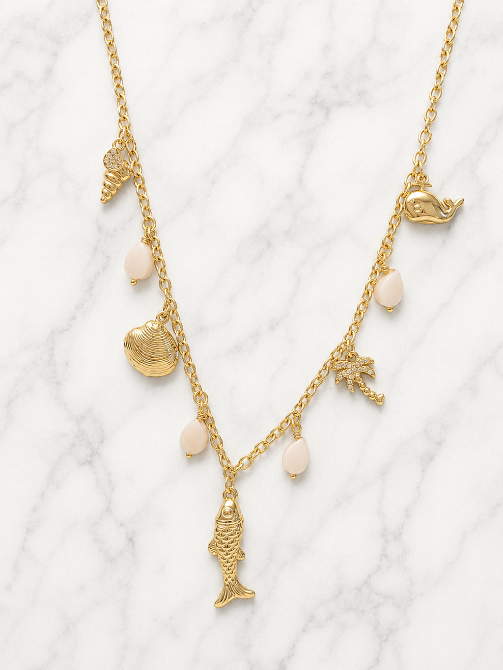 Collana dorata charms marini con palma e pietre rosa