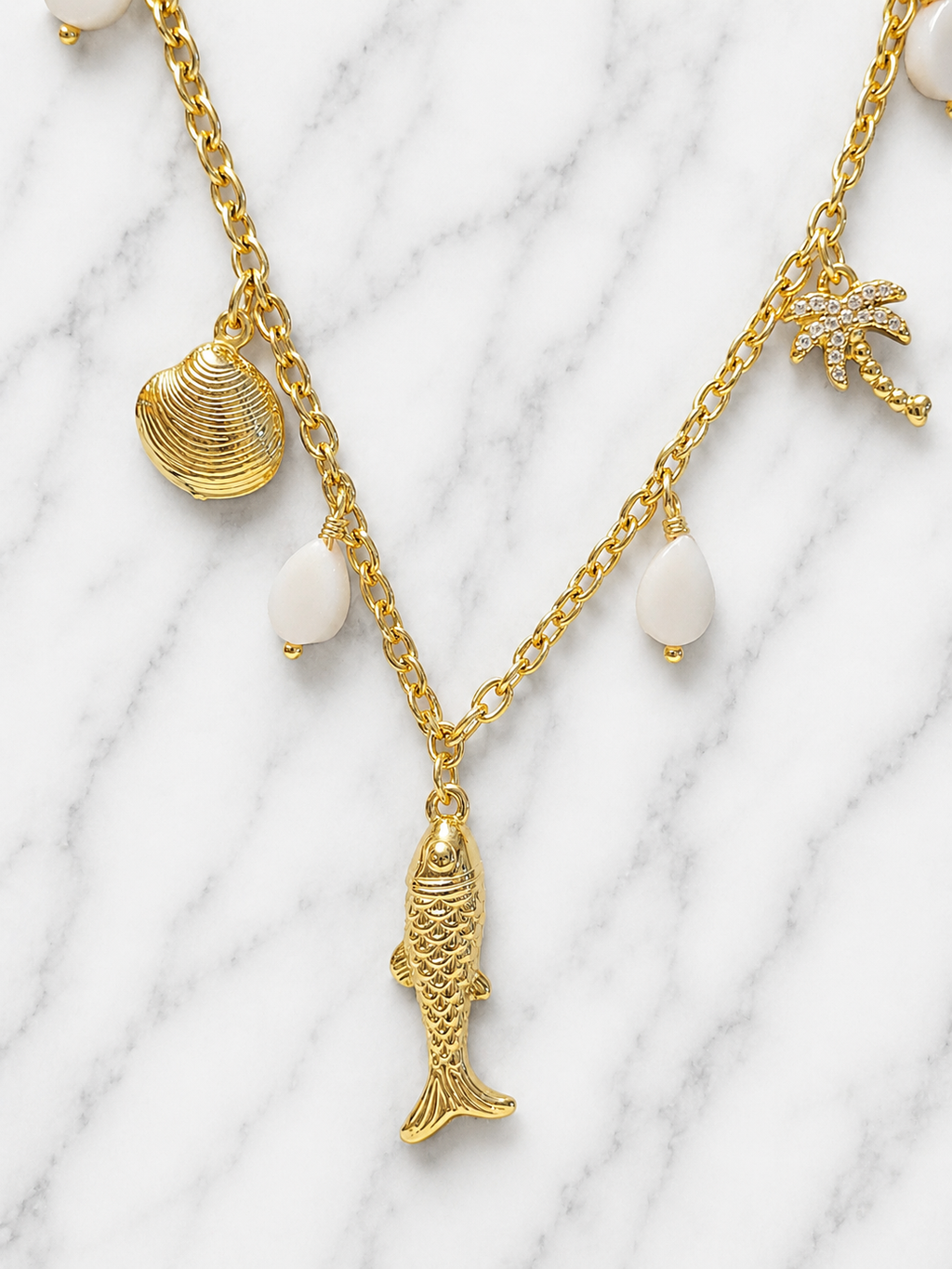 Collana dorata charms marini con palma e pietre rosa